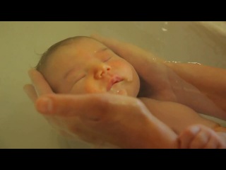 bathing the baby in the first days after birth. a nurse bathes babies in a maternity hospital in france